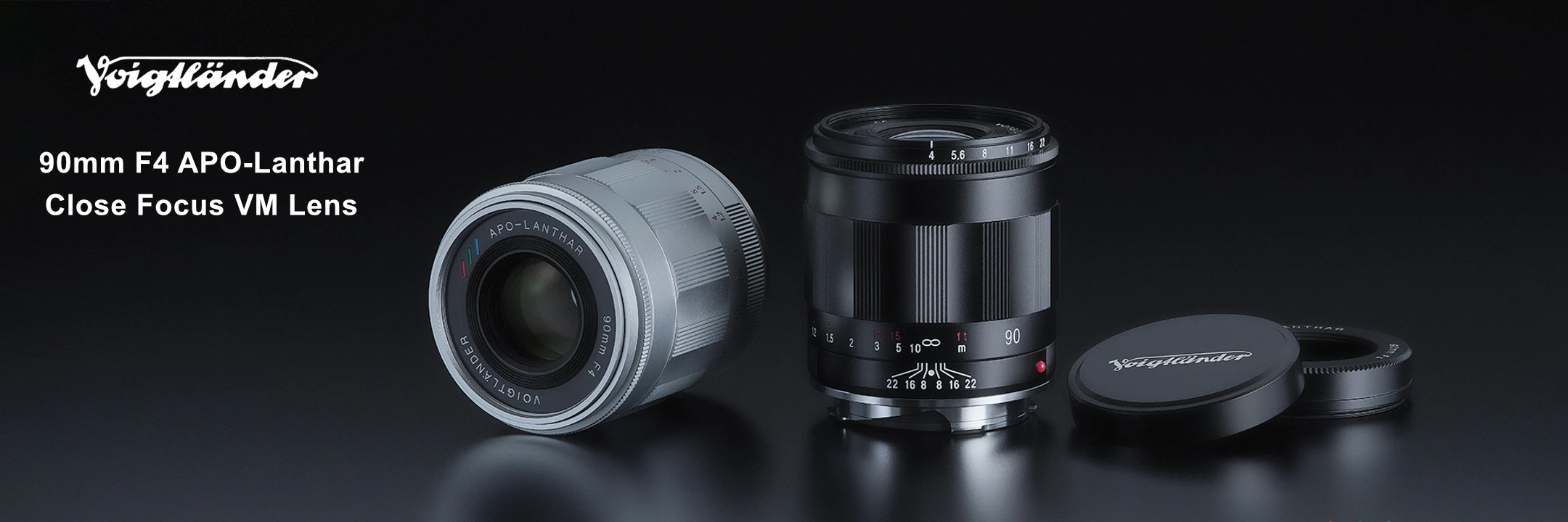 Voigtländer 90mm F4 APO-Lanther close focus VM lens shown in silver and black, alongside its black cap lid.